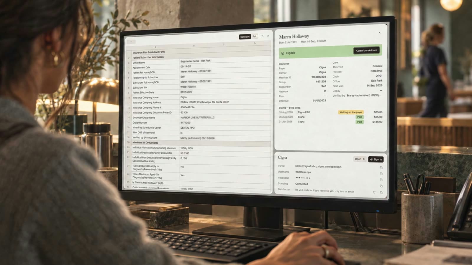 A front desk, the product on the monitor, eligibility read and set beside the patient.