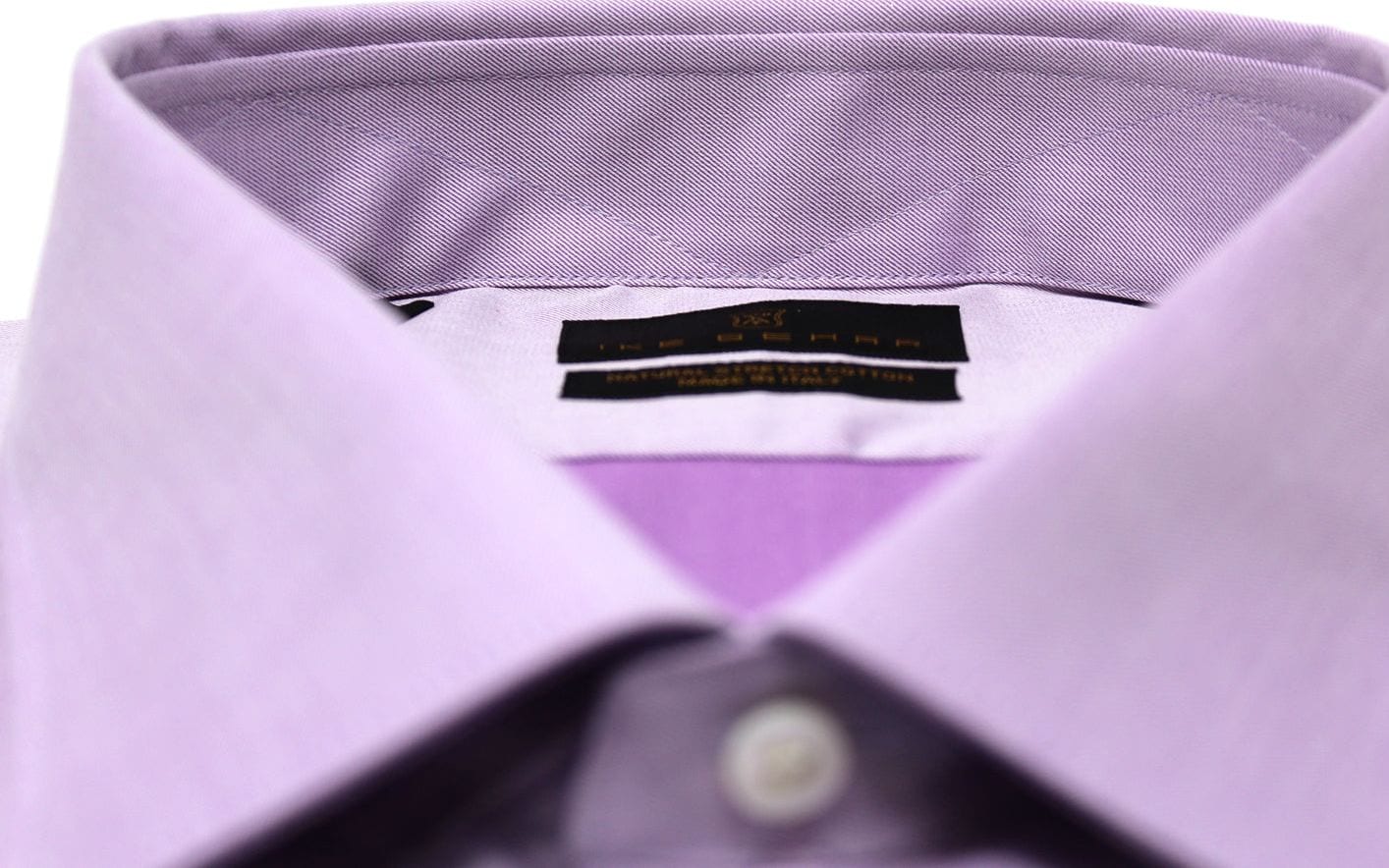 A lavender dress-shirt collar with the Ike Behar label, close up.
