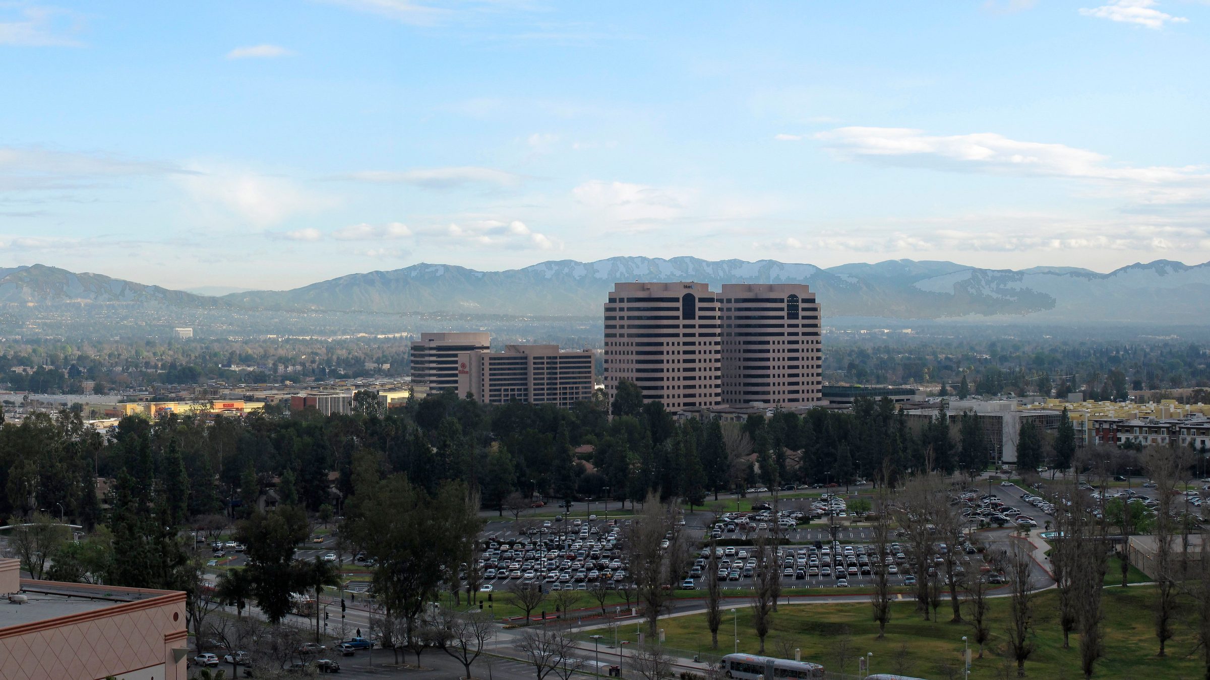 Early morning over the San Fernando Valley from Woodland Hills: the Warner Center towers, trees and the mountains beyond.
